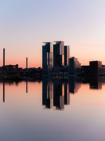 a large body of water with buildings in the background