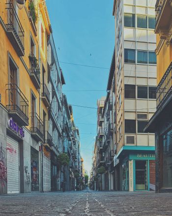 a city street lined with tall buildings next to each other