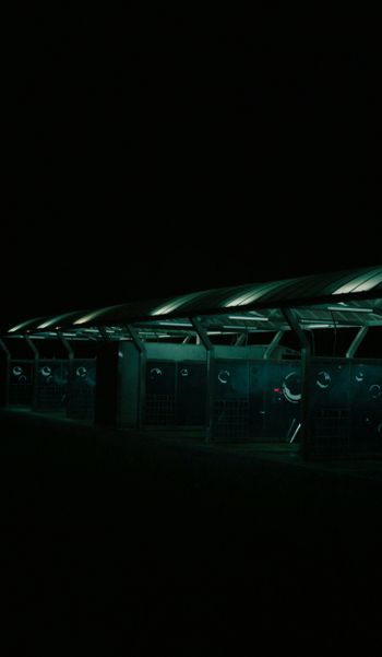 a row of metal lockers in the dark