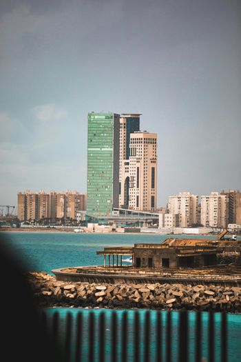 a large body of water next to a tall building