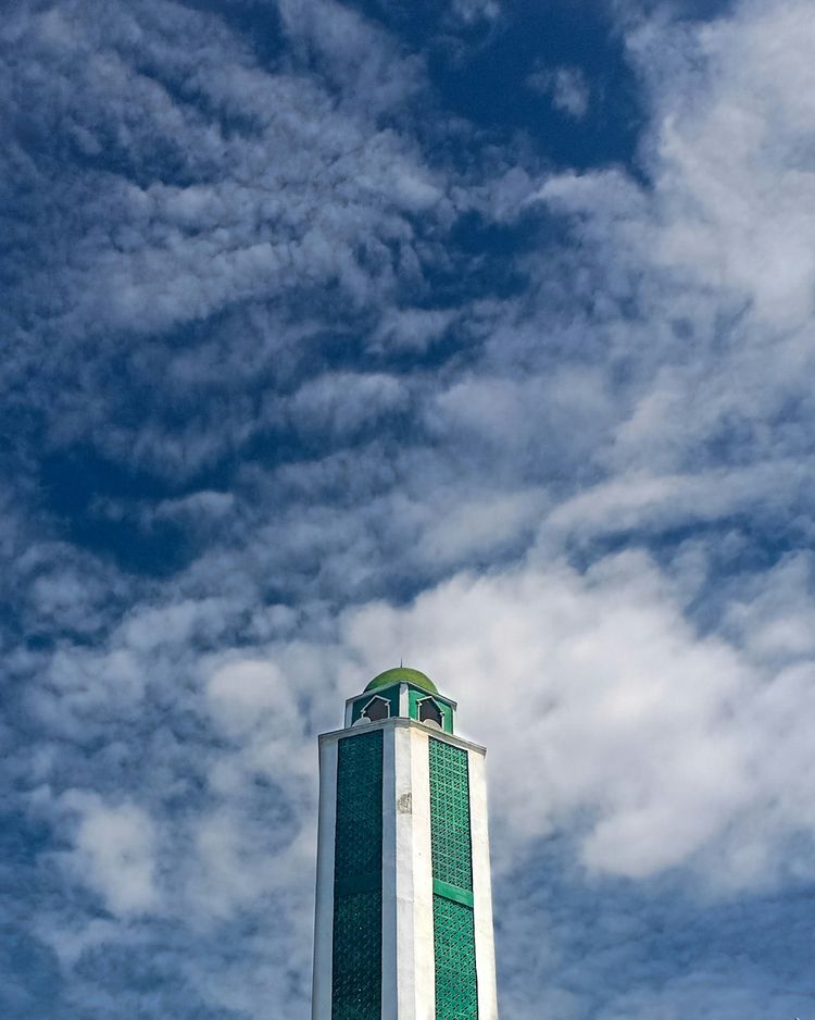 white and green concrete building under blue sky