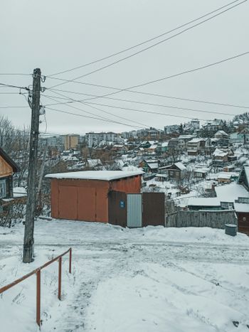 brown wooden house covered with snow during daytime