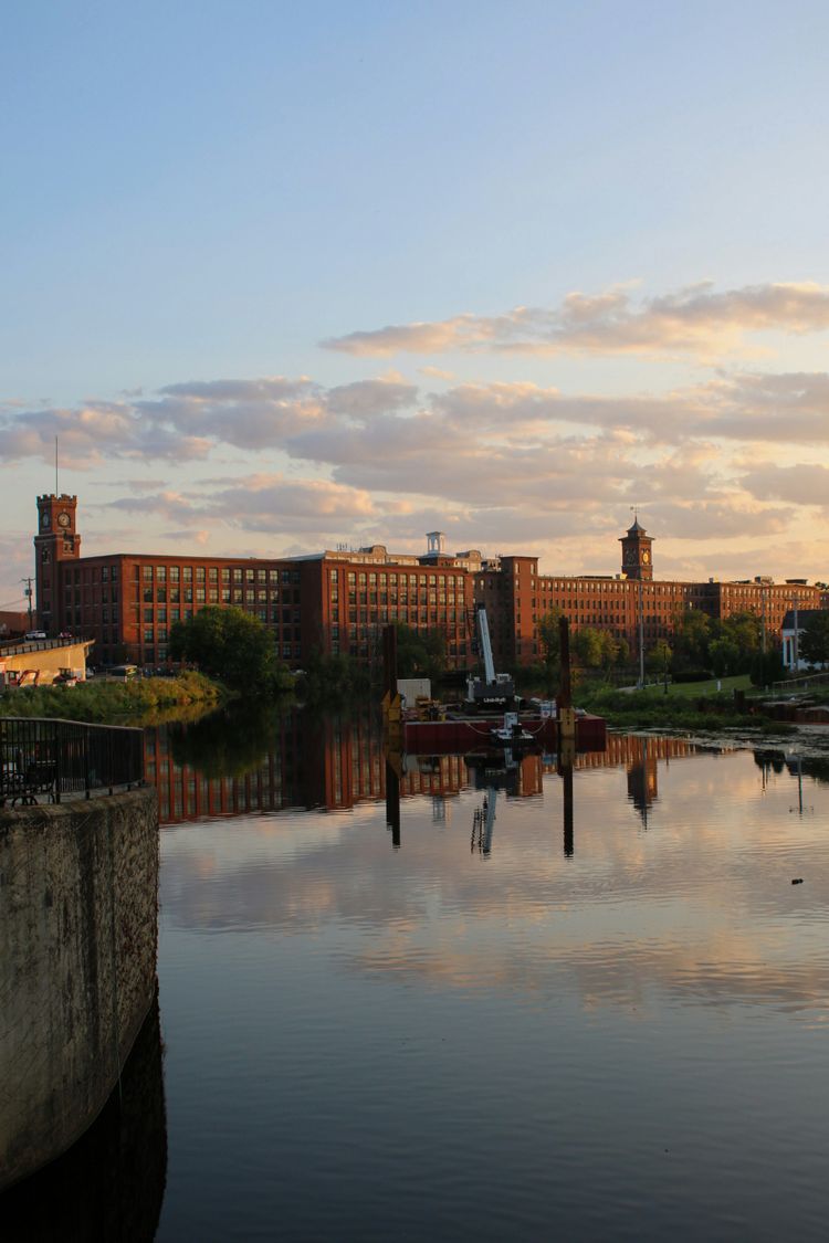A body of water with buildings in the background