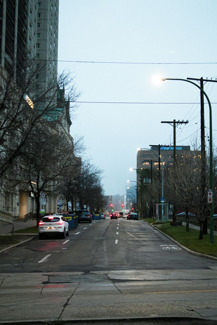 a city street with cars driving down it