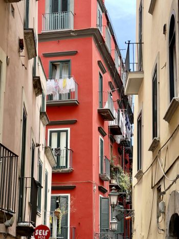 a red building with balconies and balconies on the balconies
