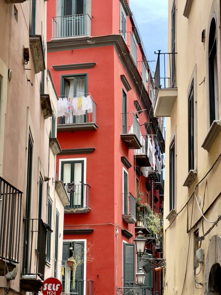 a red building with balconies and balconies on the balconies