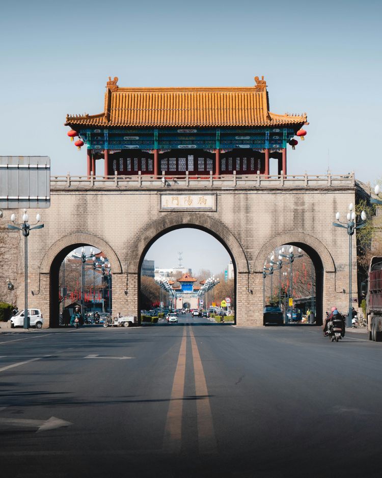 a large stone arch with a building on top of it