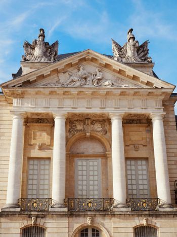 a large building with statues on top of it